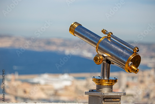 Coin operated stainless steel and brass telescope for tourists to observe the cityscape of Marseille in France
