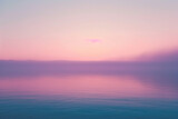 Pastel pink and purple hues over a tranquil sea at sunset