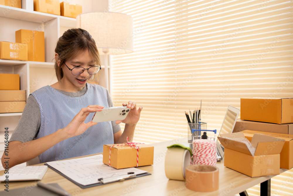 Take product photos, Asian Entrepreneur Working from Home, Sell products online, Working at Home: Online Store Management and Package Delivery. Take product photos, Asian Entrepreneur Working from Home, Sell products online, Working at Home: Online Store Management and Package Delivery.