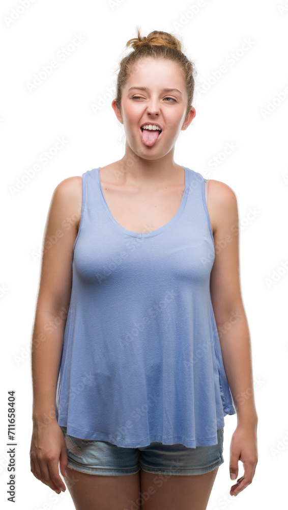 Young blonde woman sticking tongue out happy with funny expression. Emotion concept. Young blonde woman sticking tongue out happy with funny expression. Emotion concept.