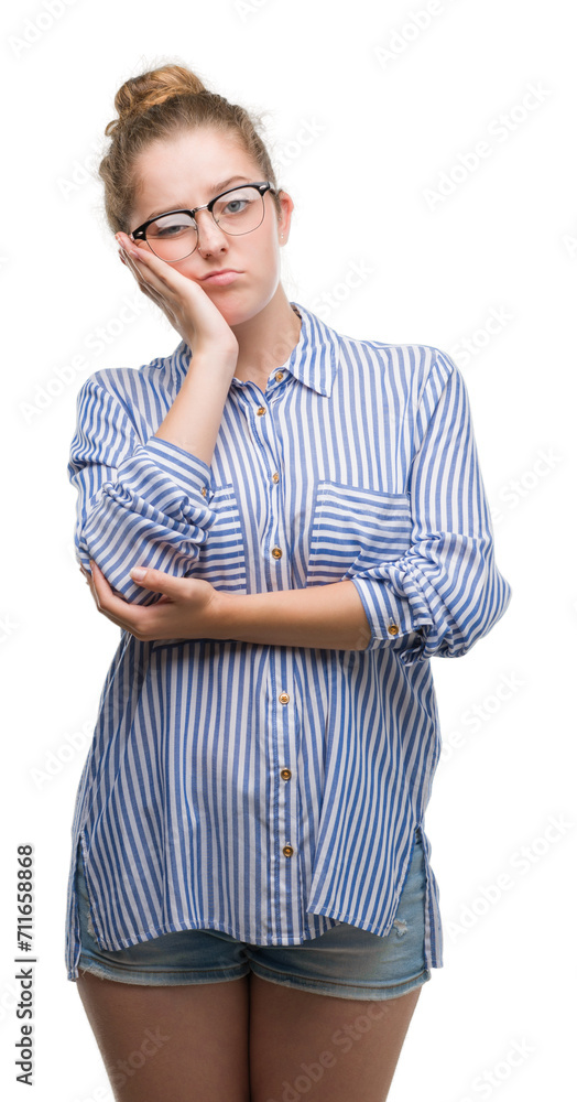Young blonde business woman thinking looking tired and bored with depression problems with crossed arms. Young blonde business woman thinking looking tired and bored with depression problems with crossed arms.