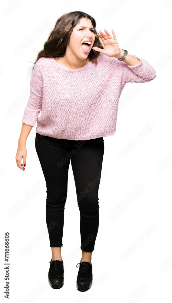 Young beautiful woman wearing pink sweater shouting and screaming loud to side with hand on mouth. Communication concept. Young beautiful woman wearing pink sweater shouting and screaming loud to side with hand on mouth. Communication concept.