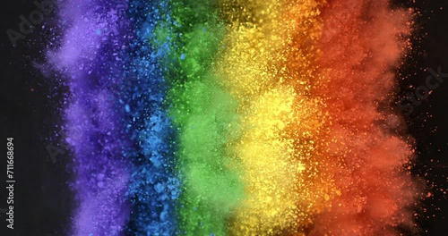 Super slow motion close up of rainbow flag of peace explosion of colorfoul powder with flying particles isolated on black background at 1000 fps. photo