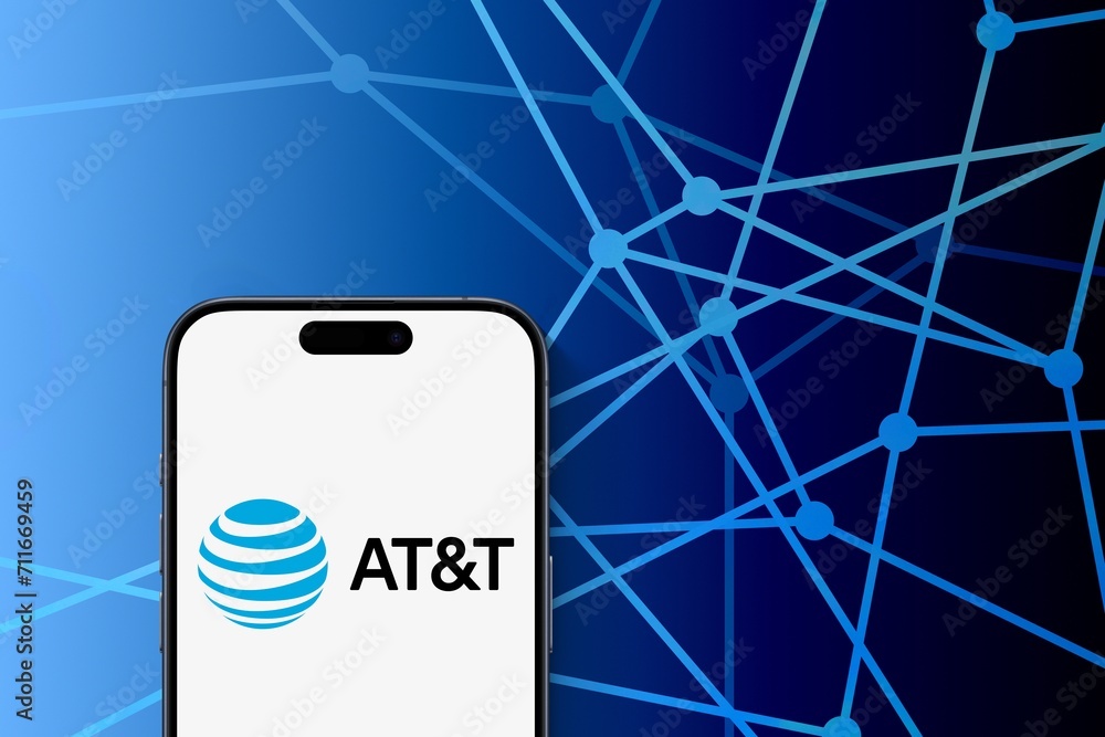 AT&T logo is displayed on a modern smartphone, blue connected dots ...