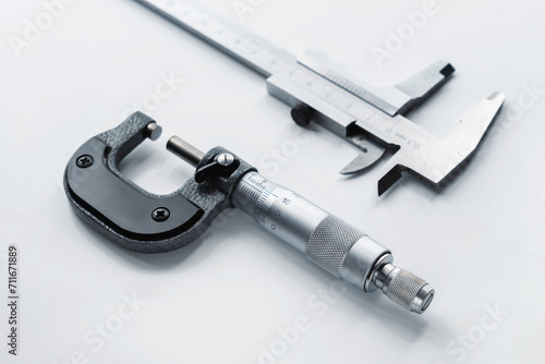 Fotografie Close-up of a mechanical micrometer and caliper on a light background