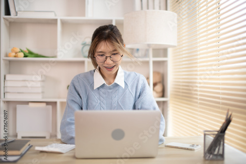 Woman typing in front of a laptop, Hand pressing laptop keyboard, Intention to work in the office. © Puwasit Inyavileart