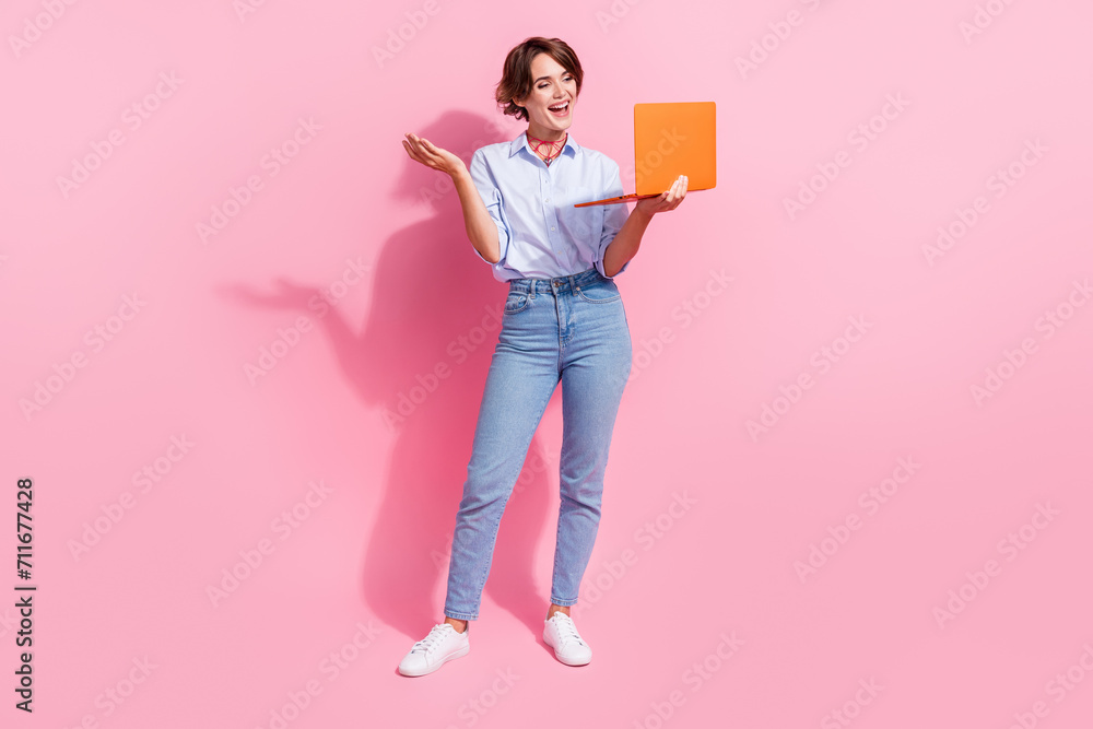 Full body photo of pretty cheerful lady communicate speak video call laptop isolated on pink color background