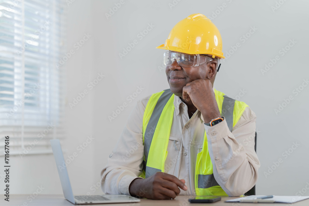 industrial engineers sitting and thoughtful in the office using digital tablet computers for the construction. industrial engineers sitting and thoughtful in the office using digital tablet computers for the construction.