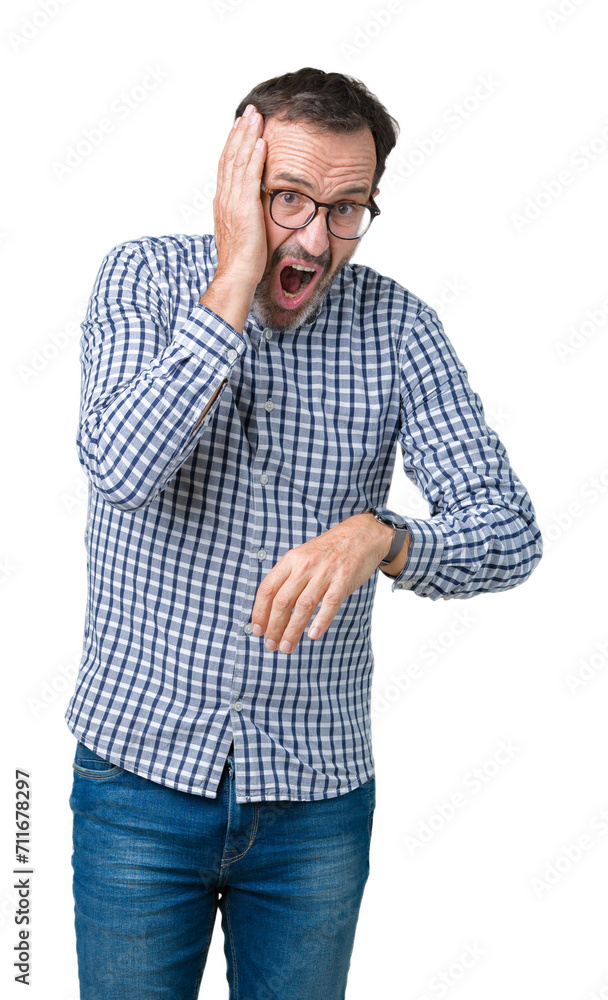 Handsome middle age elegant senior man wearing glasses over isolated background Looking at the watch time worried, afraid of getting late Handsome middle age elegant senior man wearing glasses over isolated background Looking at the watch time worried, afraid of getting late
