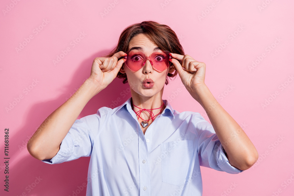 Photo of speechless shocked girl arms touch sunglass pouted lips cant believe isolated on pink color background - obrazy, fototapety, plakaty 