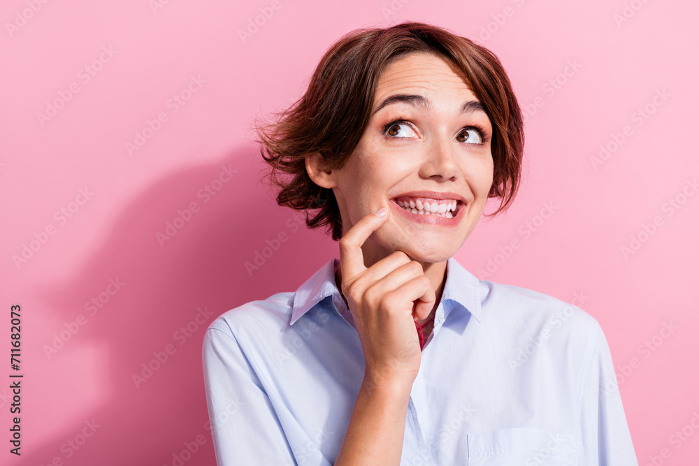Portrait of positive minded gorgeous lady finger touch chin beaming smile look empty space isolated on pink color background Portrait of positive minded gorgeous lady finger touch chin beaming smile look empty space isolated on pink color background