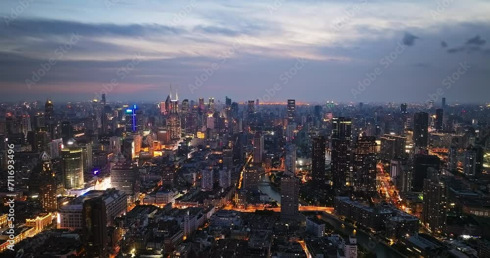 Aerial back shot of Shanghai financial district skyline and streets at night Aerial back shot of Shanghai financial district skyline and streets at night