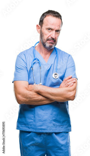 Middle age hoary senior doctor man wearing medical uniform over isolated background skeptic and nervous, disapproving expression on face with crossed arms. Negative person.
