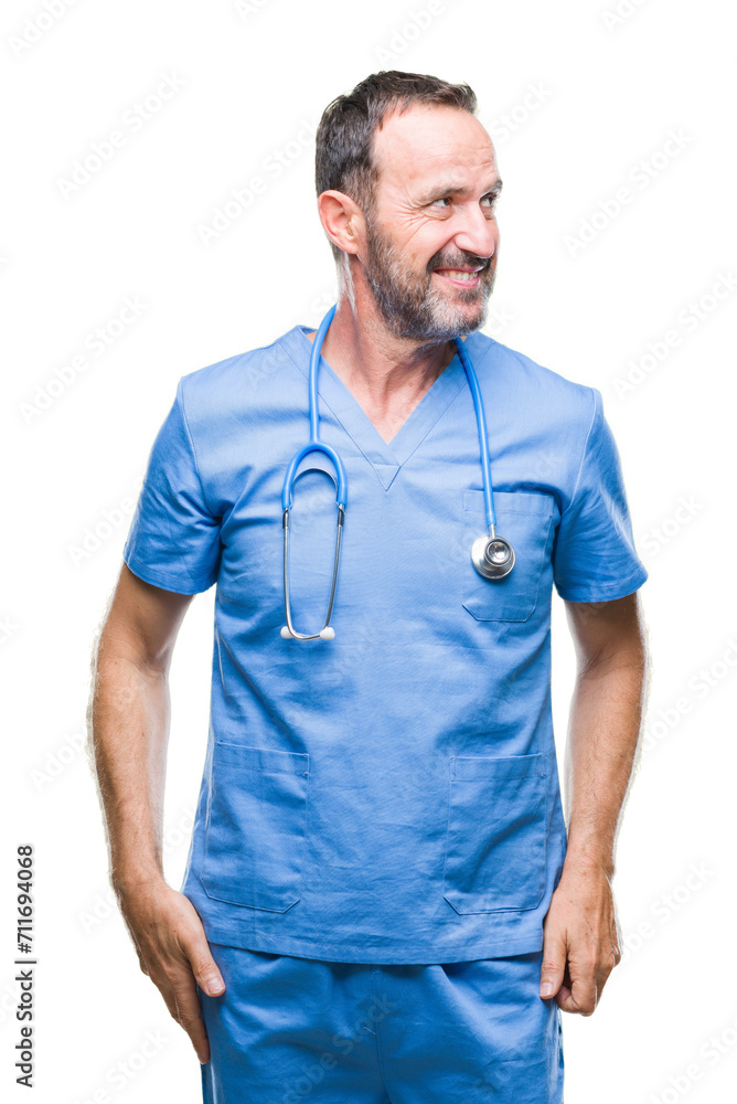 Middle age hoary senior doctor man wearing medical uniform over isolated background looking away to side with smile on face, natural expression. Laughing confident. Middle age hoary senior doctor man wearing medical uniform over isolated background looking away to side with smile on face, natural expression. Laughing confident.