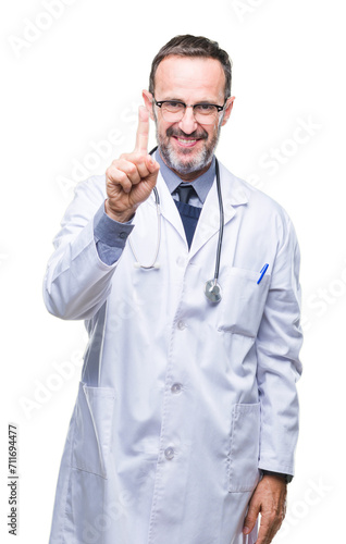 Middle age senior hoary doctor man wearing medical uniform isolated background showing and pointing up with finger number one while smiling confident and happy. © Krakenimages.com