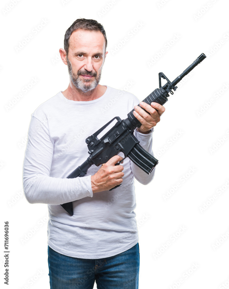 Middle age senior hoary criminal man holding gun weapon over isolated background with a confident expression on smart face thinking serious Middle age senior hoary criminal man holding gun weapon over isolated background with a confident expression on smart face thinking serious