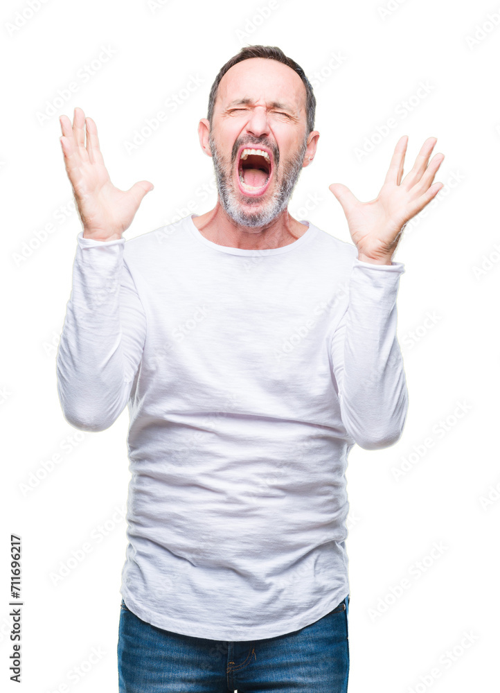Middle age hoary senior man wearing white t-shirt over isolated background celebrating mad and crazy for success with arms raised and closed eyes screaming excited. Winner concept Middle age hoary senior man wearing white t-shirt over isolated background celebrating mad and crazy for success with arms raised and closed eyes screaming excited. Winner concept