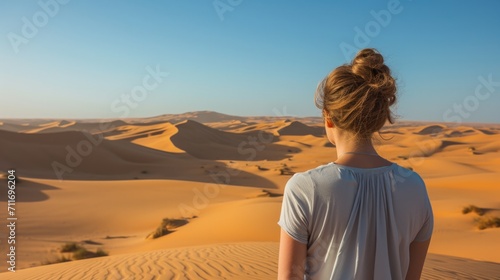 Woman from behind  looking at a vast desert landscape generative ai