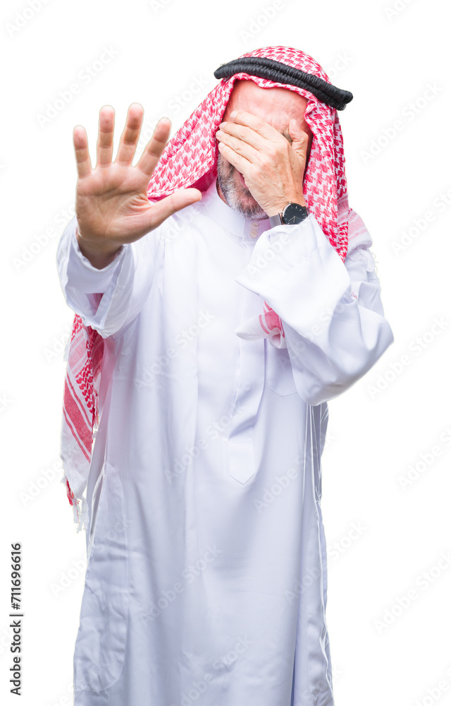 Senior arab man wearing keffiyeh over isolated background covering eyes with hands and doing stop gesture with sad and fear expression. Embarrassed and negative concept.