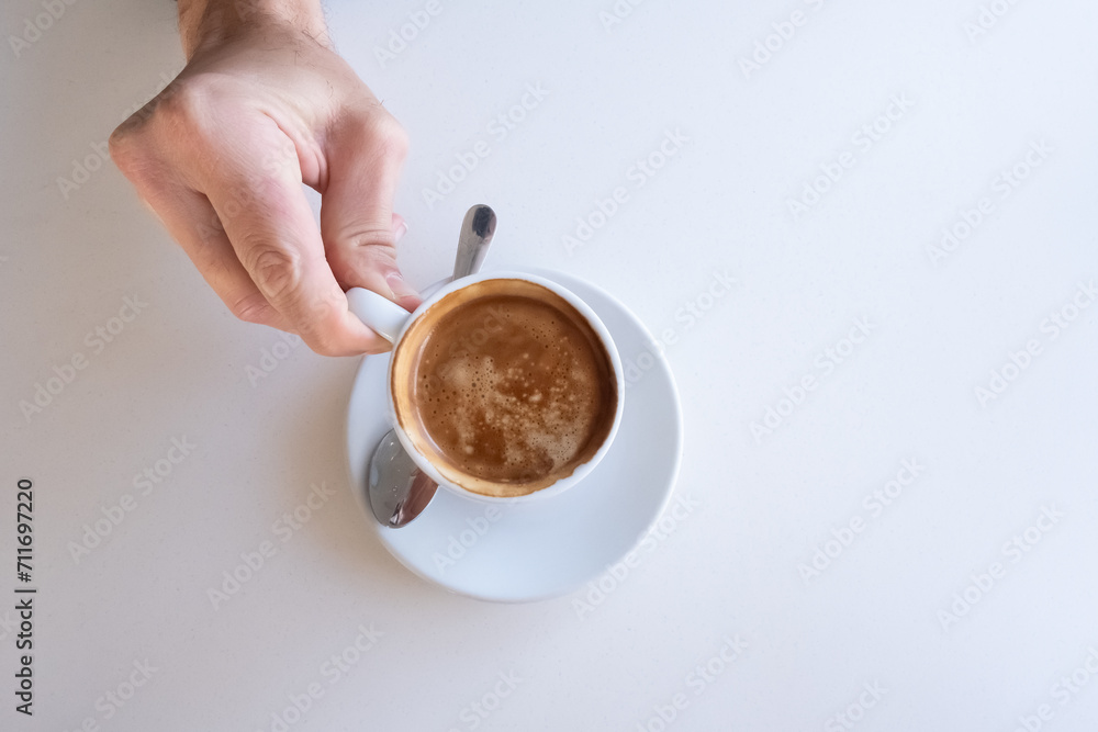 coffee on a coffee shop table with a person's hand coffee on a coffee shop table with a person's hand