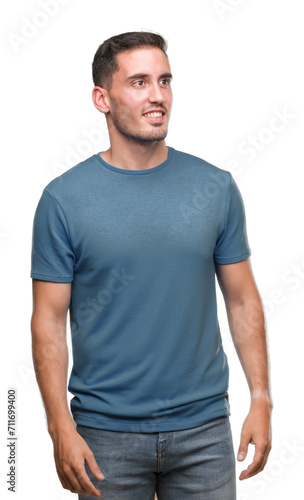 Handsome young casual man looking away to side with smile on face, natural expression. Laughing confident.