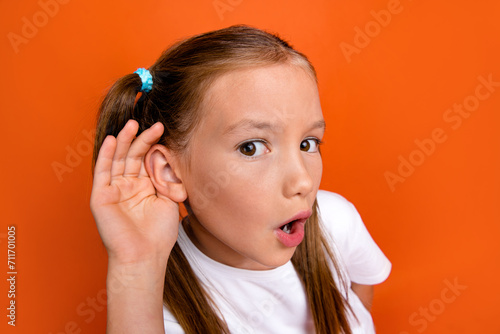 Canvas Print Portrait of impressed schoolkid arm near ear open mouth listen eavesdrop isolate
