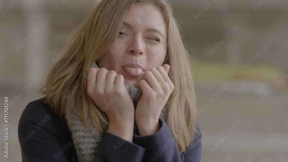 Playful Young Blonde Woman Smiling and Sticking Out Tongue Playful Young Blonde Woman Smiling and Sticking Out Tongue