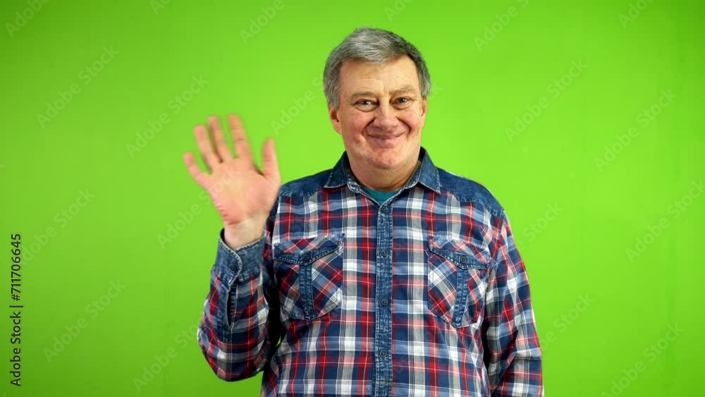 Senior man waves palm for greeting or goodbye sign Senior man waves palm for greeting or goodbye sign