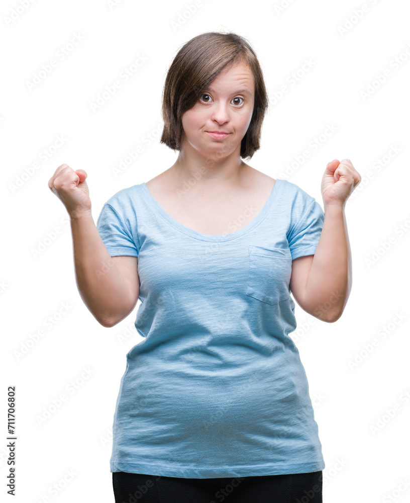 Young adult woman with down syndrome over isolated background celebrating surprised and amazed for success with arms raised and open eyes. Winner concept. Young adult woman with down syndrome over isolated background celebrating surprised and amazed for success with arms raised and open eyes. Winner concept.