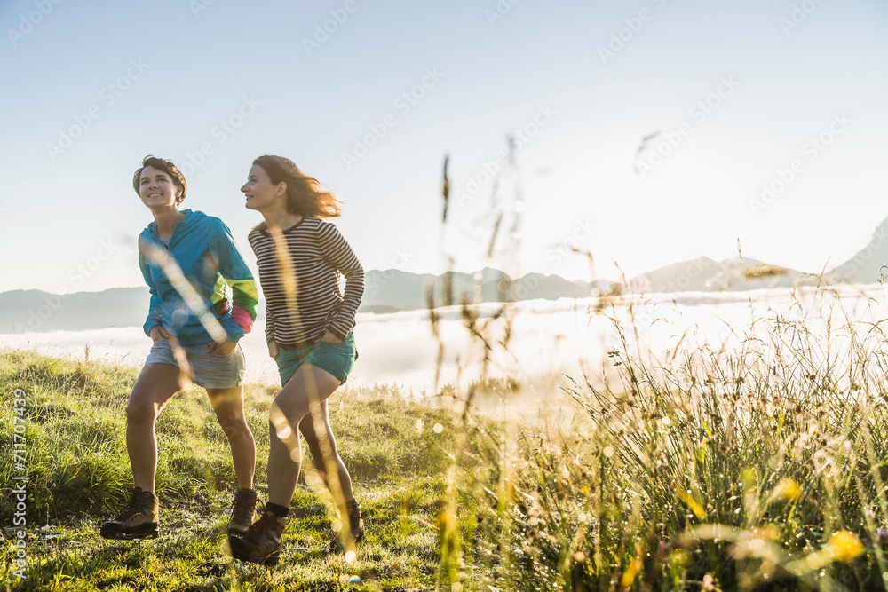 Two women having fun and laughing while in the mountains. Achenkirch, Austria Two women having fun and laughing while in the mountains. Achenkirch, Austria