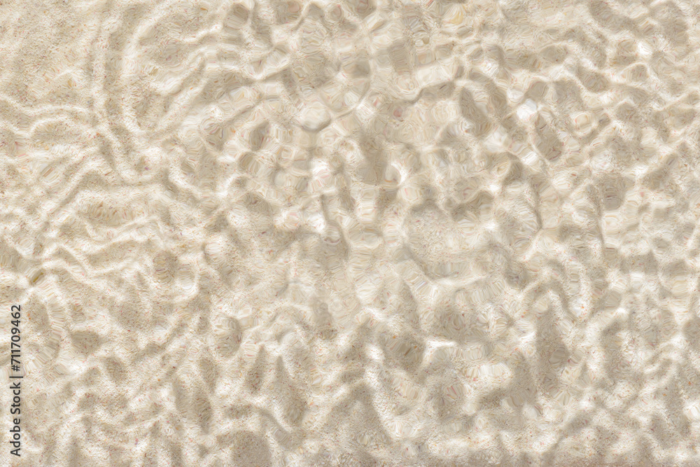 Obraz premium sun lights shadow in wavy water on abstract sand background, beautiful abstract spa concept banner of sea paradise island