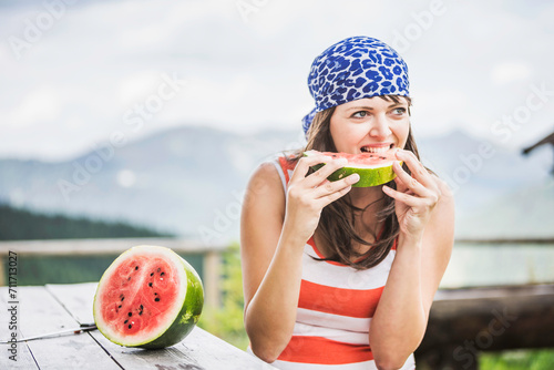 Frau mit Wassermelone in den Bergen, Falkenmoosalm, Österreich photo