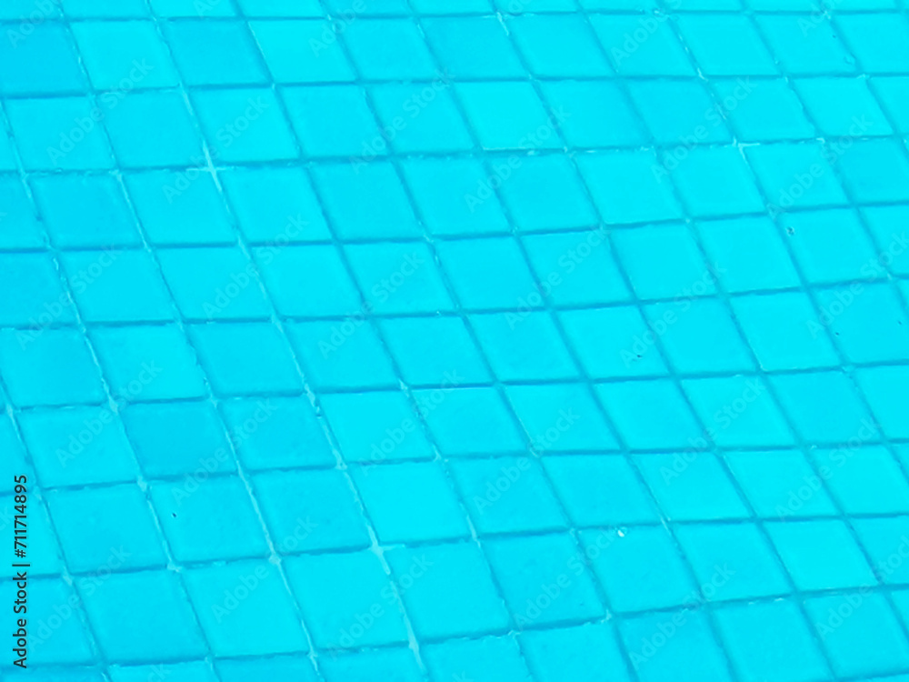 Blue water surface in swimming pool with sun reflection. Summer and abstract background. Water surface texture. Top view with copy space. Blue water surface in swimming pool with sun reflection. Summer and abstract background. Water surface texture. Top view with copy space.