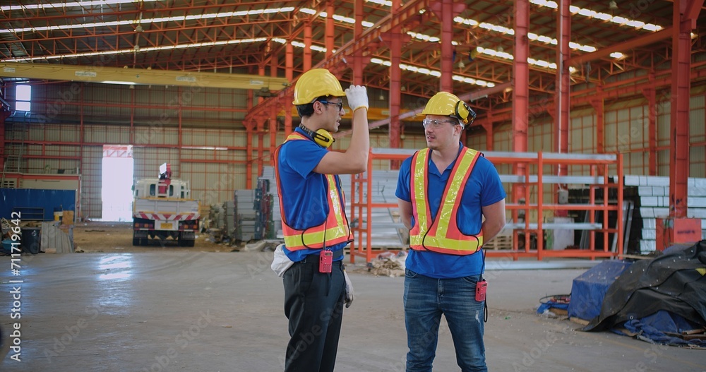 Workers partners in uniform Talking on a Meeting in Metal Construction Manufacture industry factory, Engineers man colleagues industrial discussing project work in warehouse. Team work Workers partners in uniform Talking on a Meeting in Metal Construction Manufacture industry factory, Engineers man colleagues industrial discussing project work in warehouse. Team work