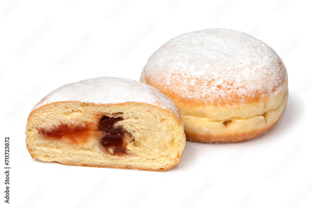 Whole and halved fresh baked Berliner donuts covered with sugar close up on white background Whole and halved fresh baked Berliner donuts covered with sugar close up on white background