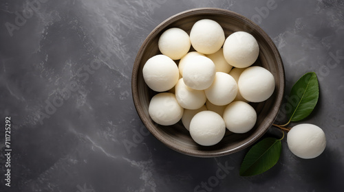 Close-up of a plate of Indian traditional sweet dessert rasgulla, bengali sweets. White Ball dumplings made of chhena dough cooked in a light sugar syrup. photo