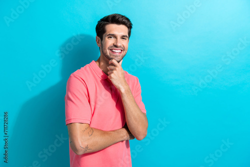 Portrait photo of thoughtful young smiling man touch chin like his experienced marketing specialist isolated on blue color background