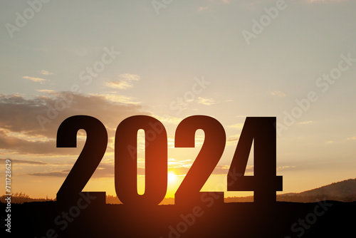 Silhouette 2024 with sunset sky at mountain and number like 2024 abstract background. Concept of start with strategy, win, plan, goal and objective target.