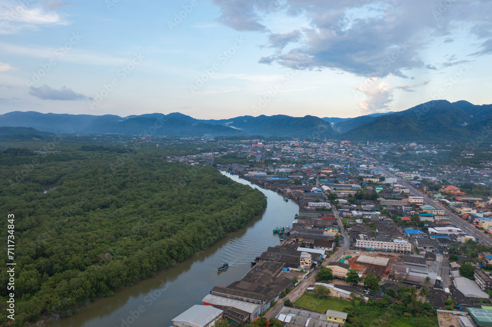 Fototapeta premium Aerial view of Ranong City, The Floating village urban city town houses, lake sea or river. Nature landscape fisheries and fishing tools, Thailand. Aquaculture farming