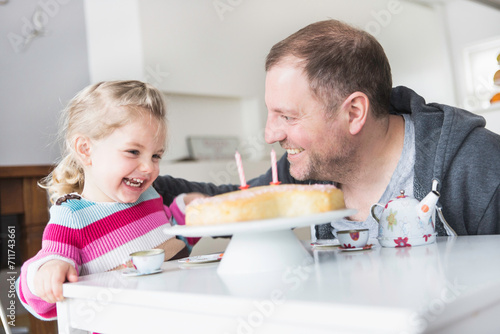 Father and his daughter celebrating her second birthday together. Munich, Bavaria, Germany photo