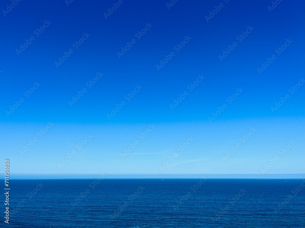 Blue seascape background, clear blue sky and blue sea horizon, natural colors