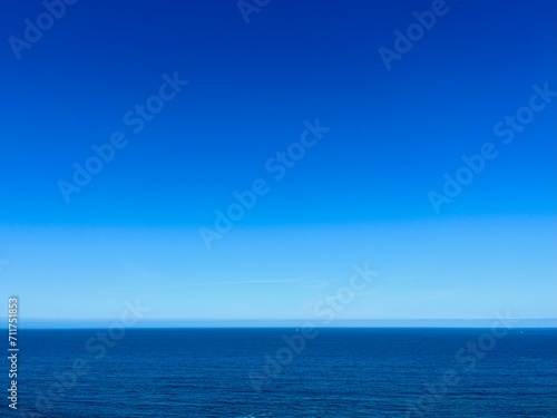 Blue seascape background, clear blue sky and blue sea horizon, natural colors