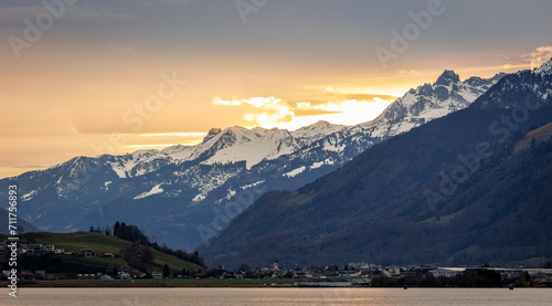 sunrise over the mountains of switzerland at upper lake zurich