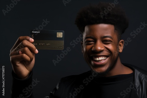 A man securely holds a credit card in his hand, ready for online or in-person transactions, Happy black man holds his credit card towards the camera, AI Generated photo