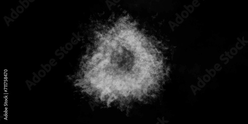 White snow ball made of fluffy snowflakes on a black background. Abstract steam on a black background.