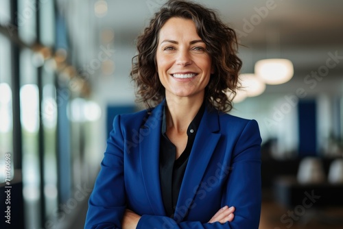 Fotografia Smiling Woman in Blue Suit Stands With Arms Crossed, Happy smiling middle aged p