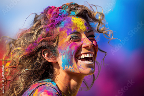 Happy woman smiling with joy, with her face painted amidst a cloud of pink powder at a Holi festival celebration. Spring and love festival.