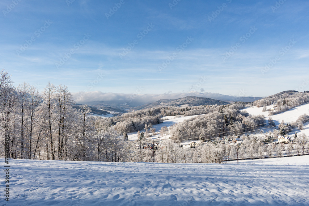Fantastic winter landscape with wooden house in snowy mountains. Hight mountain peaks in foggy sunset sky. Christmas and winter vacations holiday concept Fantastic winter landscape with wooden house in snowy mountains. Hight mountain peaks in foggy sunset sky. Christmas and winter vacations holiday concept