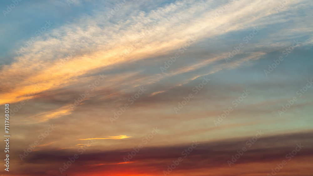 Obraz premium Sunset sky on twilight in the evening with orange gold sunset cloud nature sky backgrounds. Romantic summer sky at sunset.