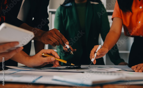 Male mature caucasian ceo businessman leader with diverse coworkers team, executive managers group at meeting. Multicultural professional businesspeople working together on research plan in boardroom.